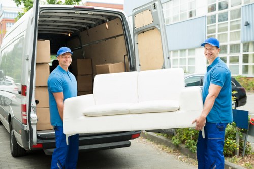 Movers preparing for a household relocation, packing boxes and planning