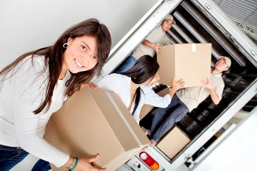 Unpackers organizing items in a new home