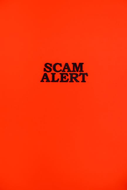 A bright red background featuring the bold black text 'SCAM ALERT' centered on the image. The design is simple and direct, intended to draw immediate attention to warning about potential scams. The im